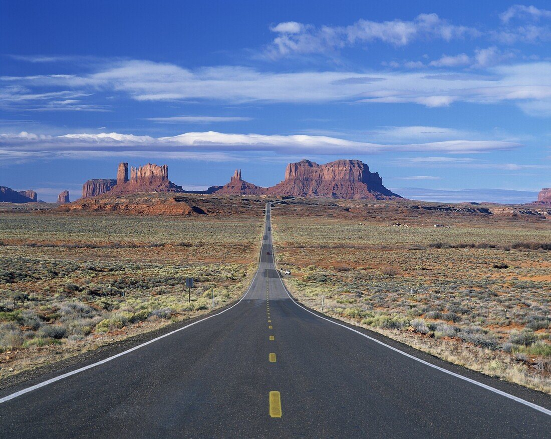 Straight road heading for Monument Valley, Navajo Reserve, on border of Arizona and Utah, United States of America, North America