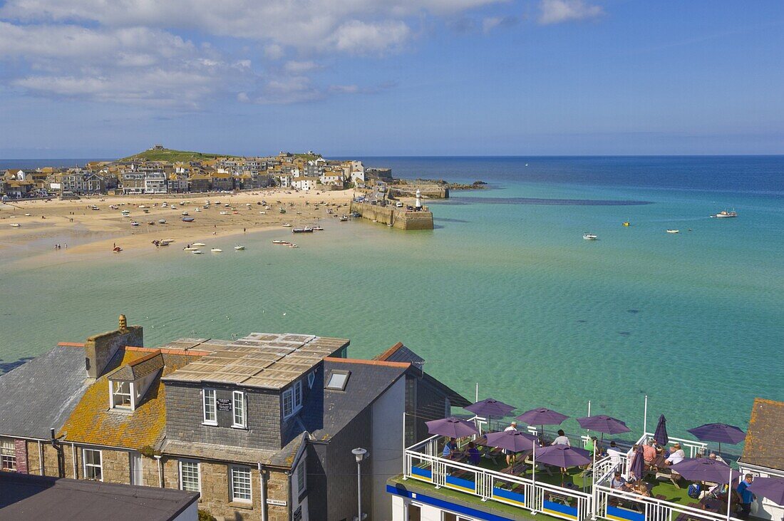 Low tide, looking over the rooftops and across the harbour at St. Ives ( Pedn Olva ) towards The Island or St. Ives head, North Cornwall, England, United Kingdom, Europe