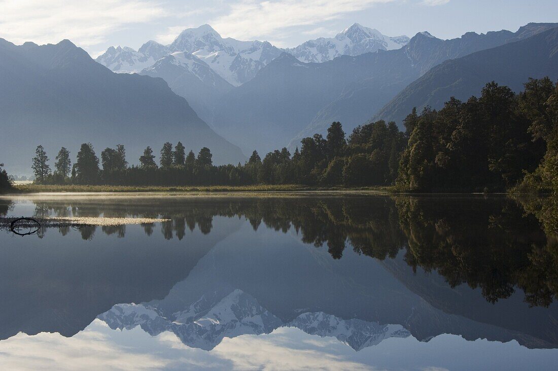 Lake Matheson reflecting a near perfect image of Mount Tasman and Aoraki (Mount Cook), 3754m, Australasia's highest mountain, Southern Alps, South Island New Zealand, Pacific