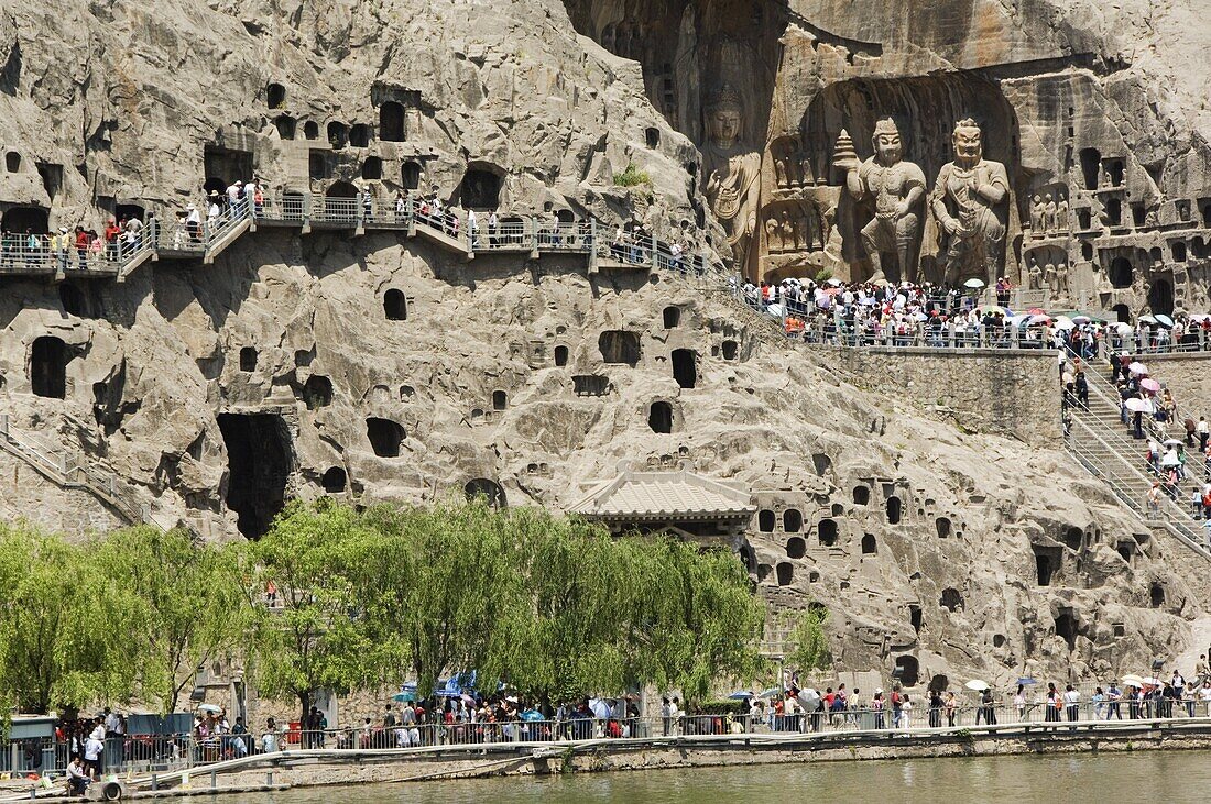 Carved Buddha images at Longmen Caves, Dragon Gate Grottoes, on the Yi He River dating from the 6th to 8th Centuries, UNESCO World Heritage Site, Henan Province, China, Asia