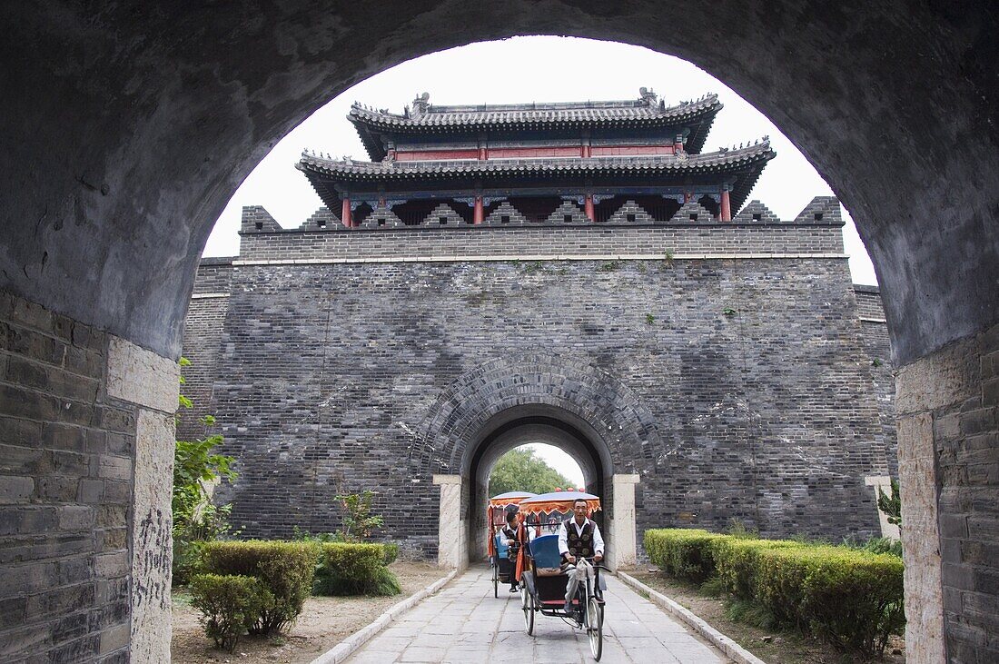 Tourist rickshaw at a city gate watch tower, Qufu City UNESCO World Heritage Site, Shandong Province, China, Asia