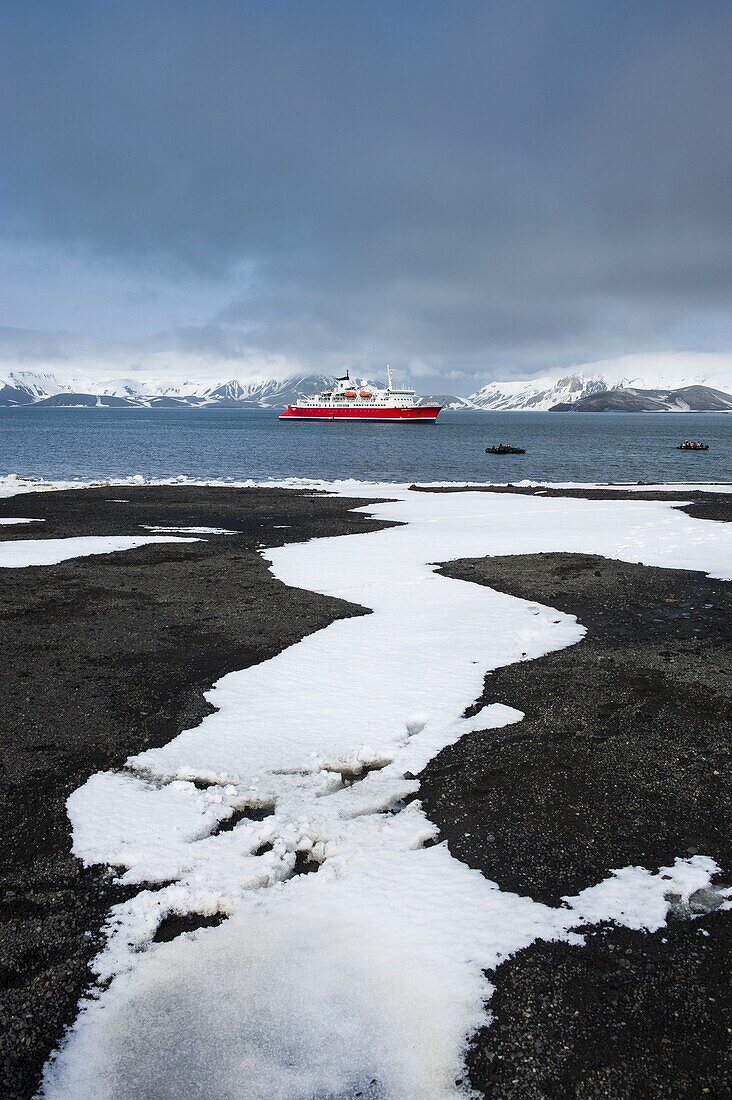 Cruise ship anchoring in the volcanic crater of Deception Island, South Shetland Islands, Antarctica, Polar Regions