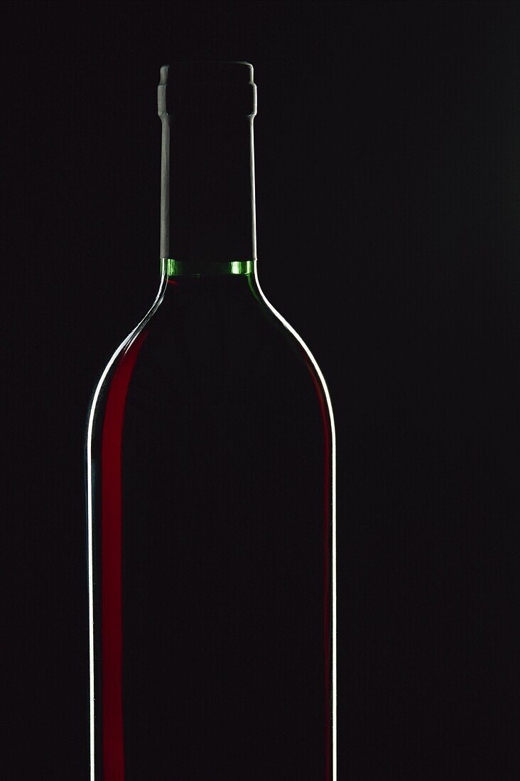 Backlit shot of a bottle of red wine