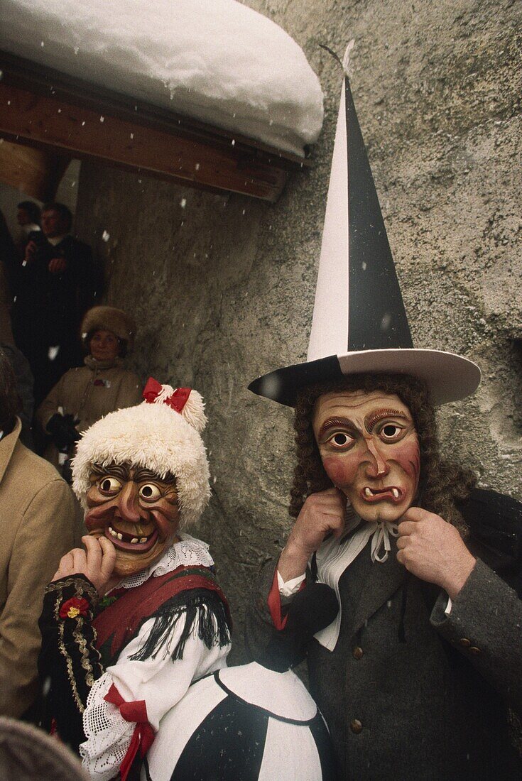 People wearing masks, one with a tall pointed hat, Fasnacht carnival, Imst, Austria, Europe