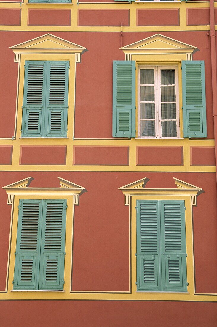 Exterior of a formal facade, brightly painted, with blue shutters and orange walls, Ajaccio, island of Corsica, France, Mediterranean, Europe