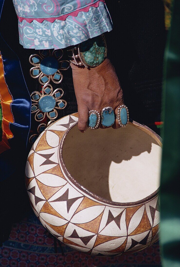 Close-up of turquoise jewellery on the hand of an Indian holding a decorated bowl, New Mexico, United States of America, North America