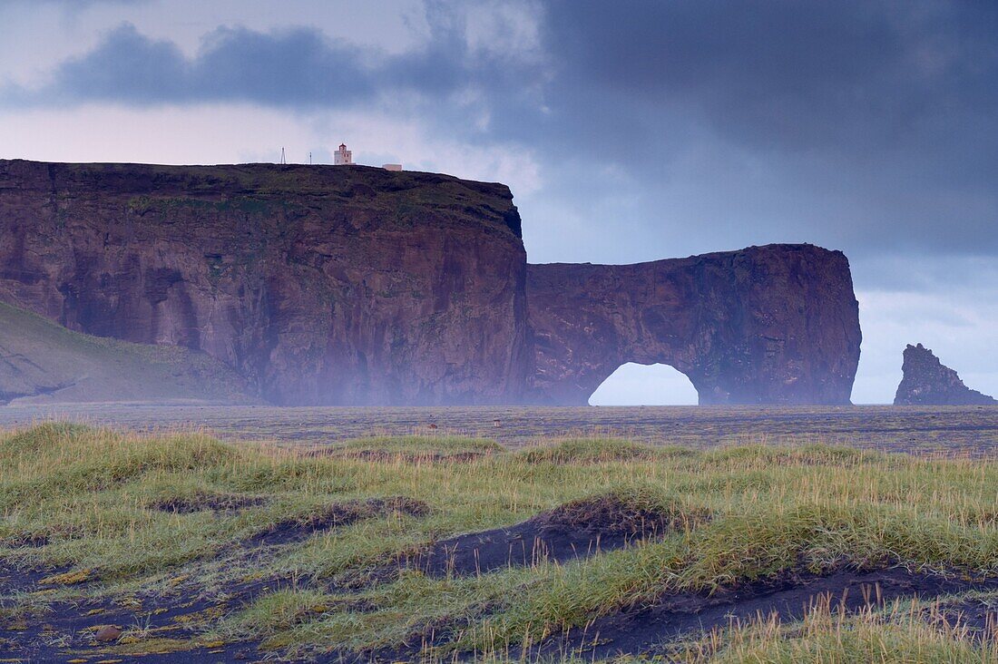 Dyrholaey inselberg and cliffs, southernmost point of Iceland, from the low-lying coast near Vik, Iceland, Polar Regions