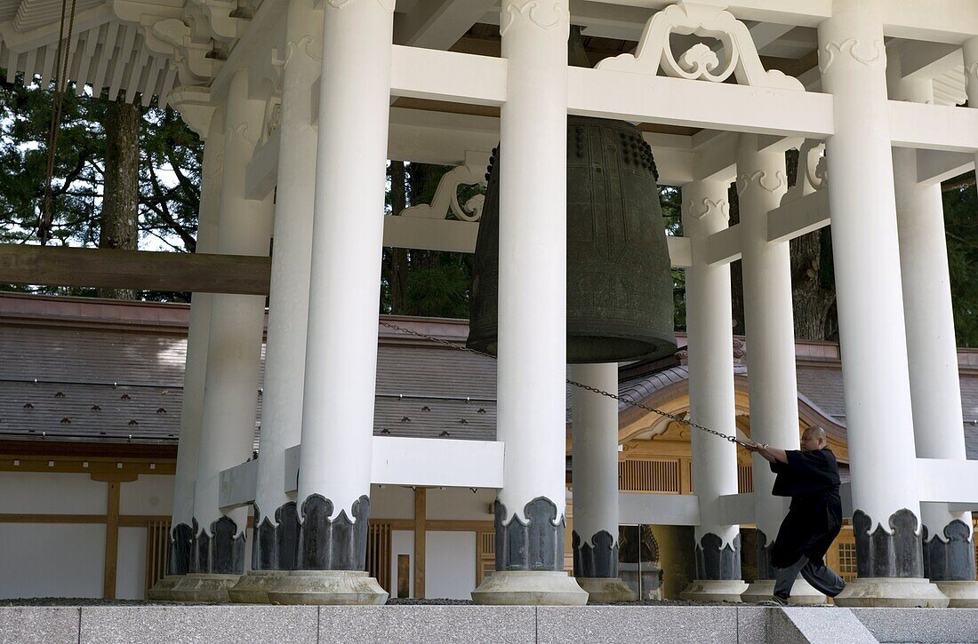 Buddhist monk ringing temple bell Daito no Kane at the Dai Garan area of Mount Koya, Wakayama, Japan, Asia