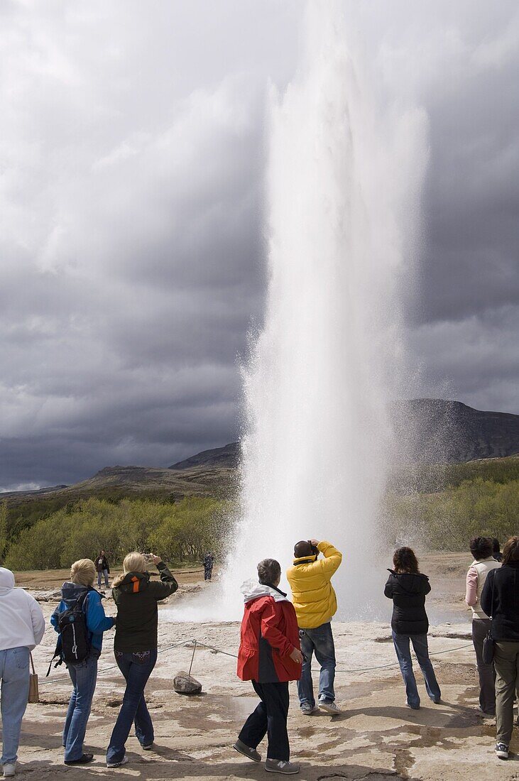 Tourists watching Strokkur Geyser erupting, Geysir, Iceland, Polar Regions