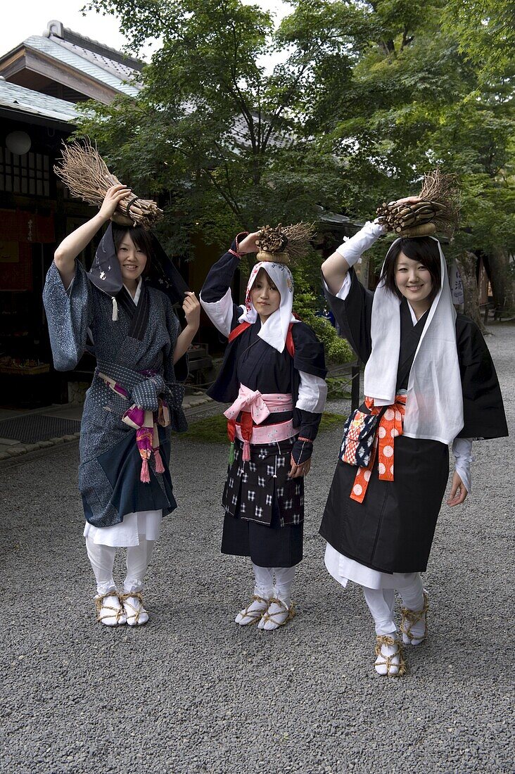 Oharame (Ohara girls) in traditional costume carrying fire wood in the rural village of Ohara, Kyoto, Japan, Asia