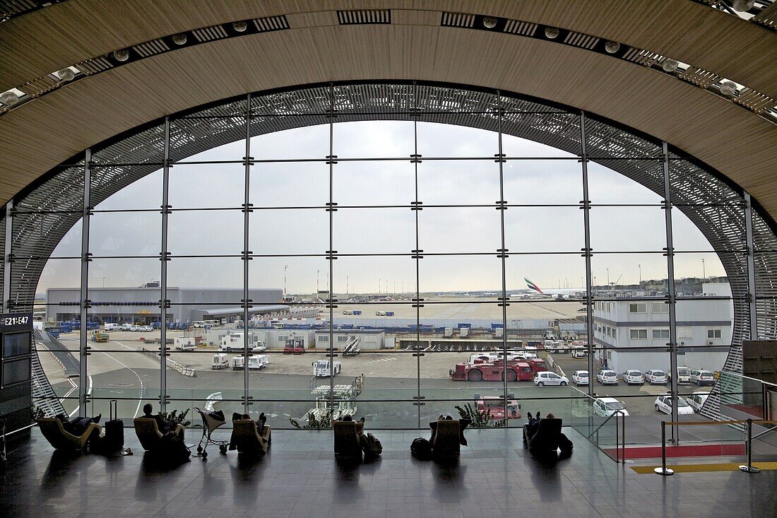 Businessmen and travellers resting on couches in Terminal 2, Paris Charles de Gaulle international airport, Roissy, France, Europe