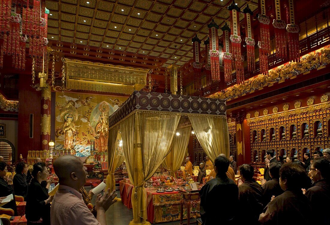 Chanting in the Hundred Dragons hall in the Buddha Tooth Relic temple in Singapore, Southeast Asia, Asia