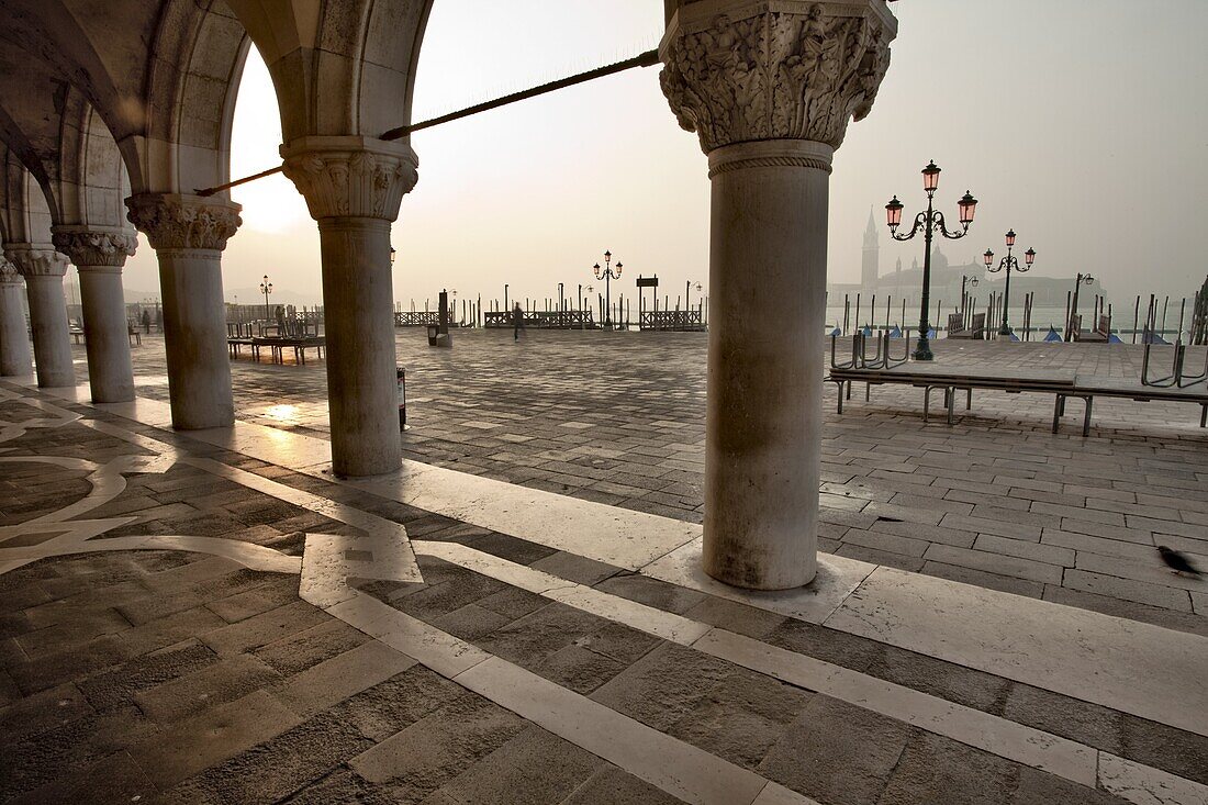Cloisters of the Palazzo Ducale, St Marks Square, looking to Isola di San Giorgio Maggiore in the early morning, Venice, UNESCO World Heritage Site, Veneto, Italy, Europe
