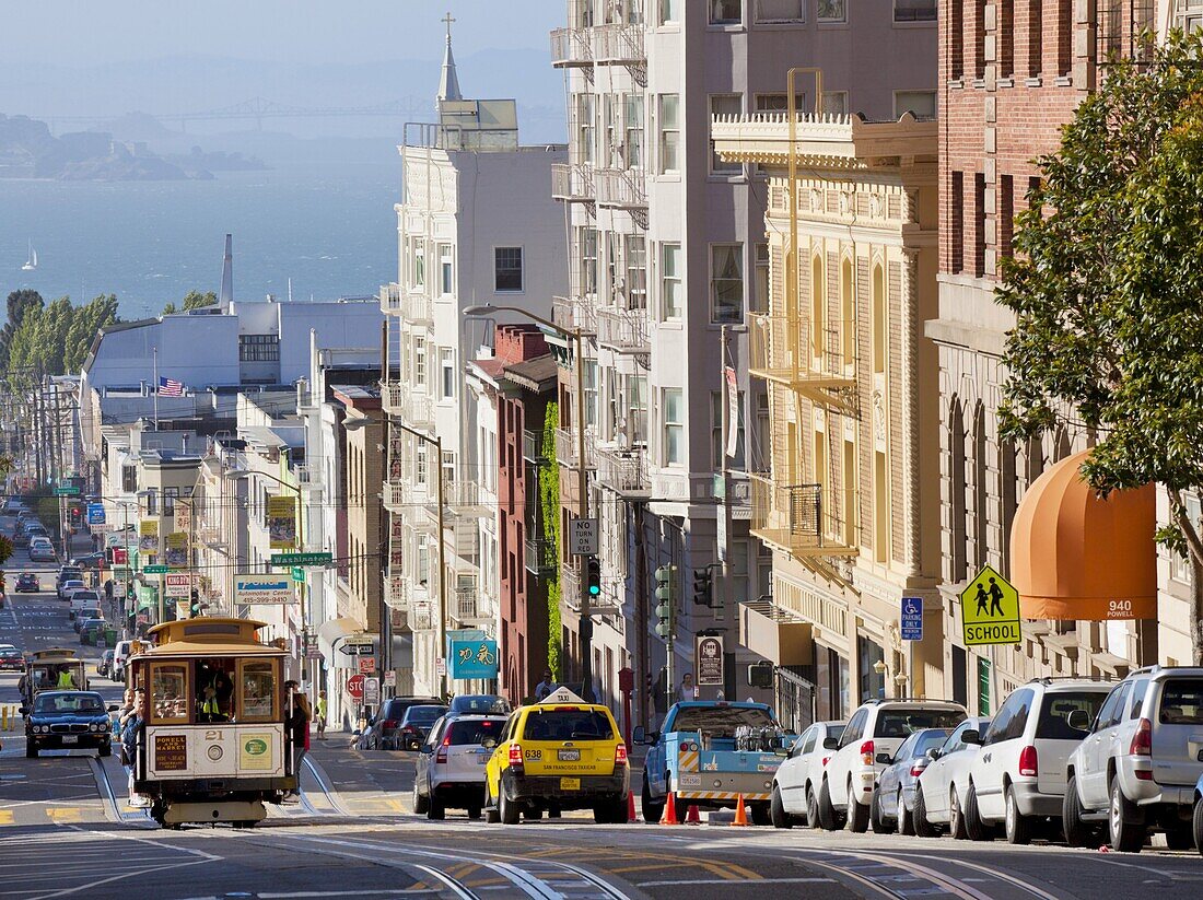 One of the famous cable cars on the Powell-Mason track, with the island of Alcatraz in the background, San Francisco, California, United States of America, North America
