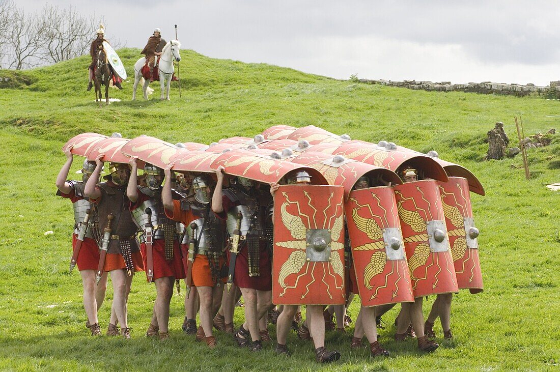Ermine Street Guard advancing with protective shields, cavalry in attendance, Birdoswald Roman Fort, Hadrians Wall, Northumbria, England, United Kingdom, Europe