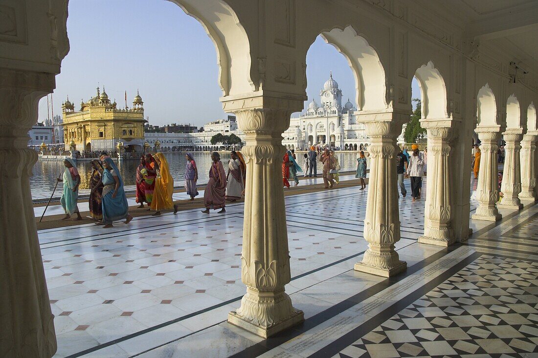 Group of Sikh women pilgrims walking around holy pool, Golden Temple, Amritsar, Punjab state, India, Asia