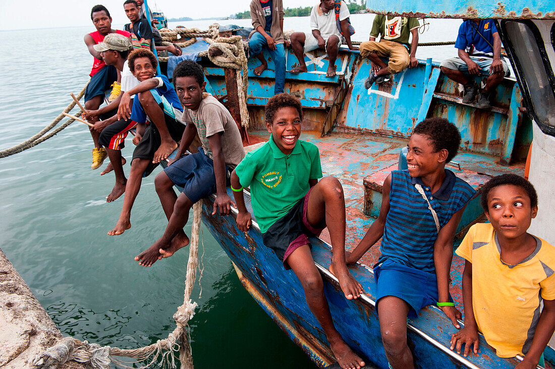 Teenagers gathering on a fishing boat, Lorengau, Manu Province, Papua New Guinea, South Pacific