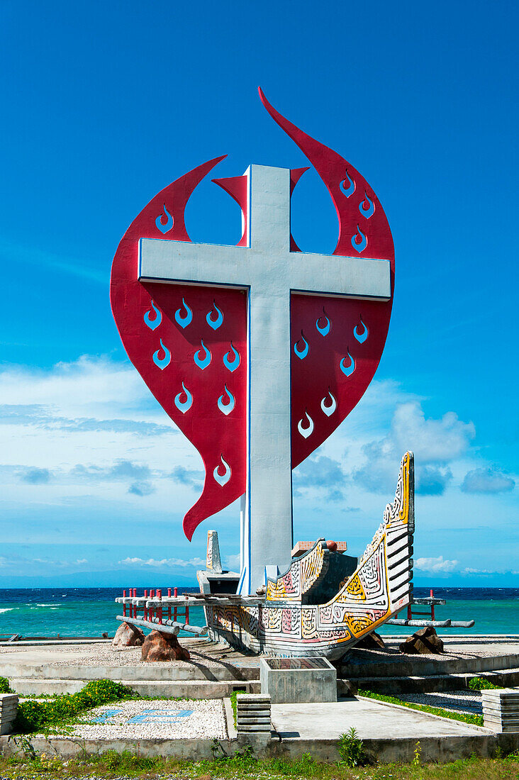 Memorial with canoe and cross on beach, Biak, Papua, Indonesia, Asia