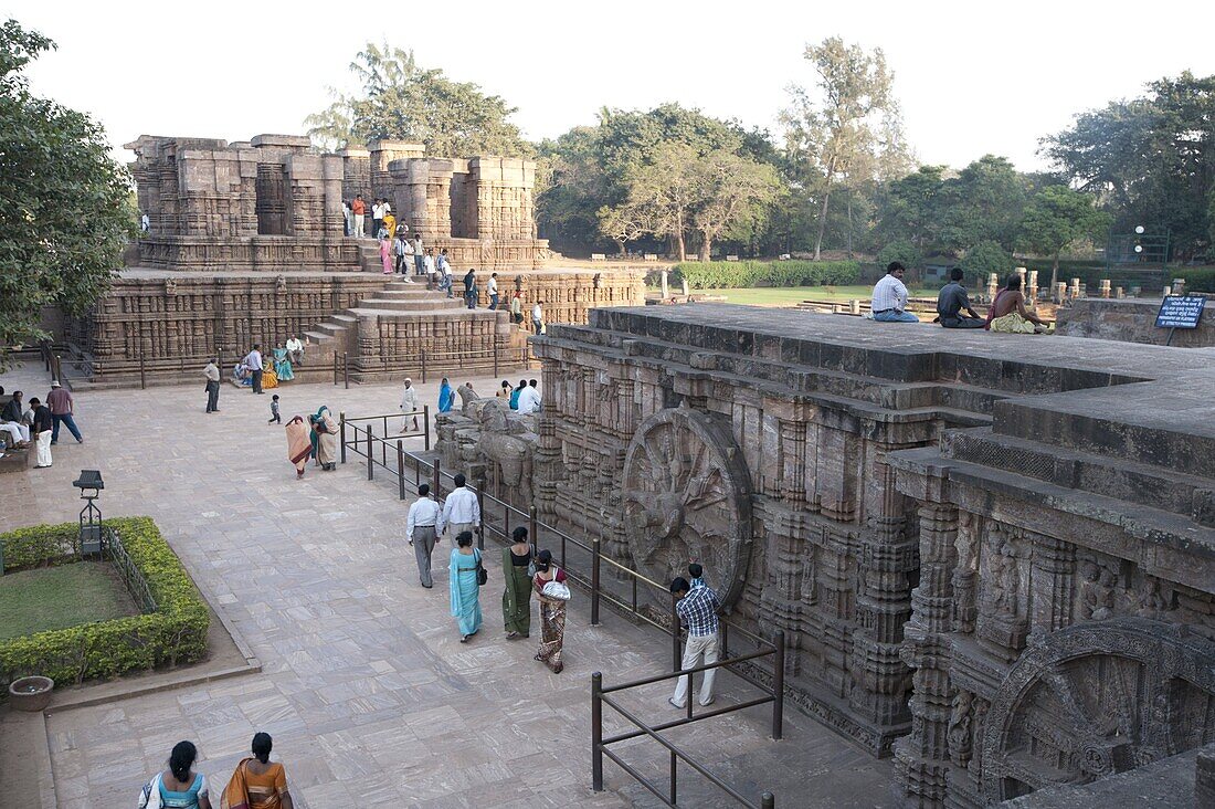 Visitors at the 13th century Konarak Sun temple, built as a chariot for Surya, the sun god, in the afternoon, UNESCO World Heritage Site, Konarak, Orissa, India, Asia