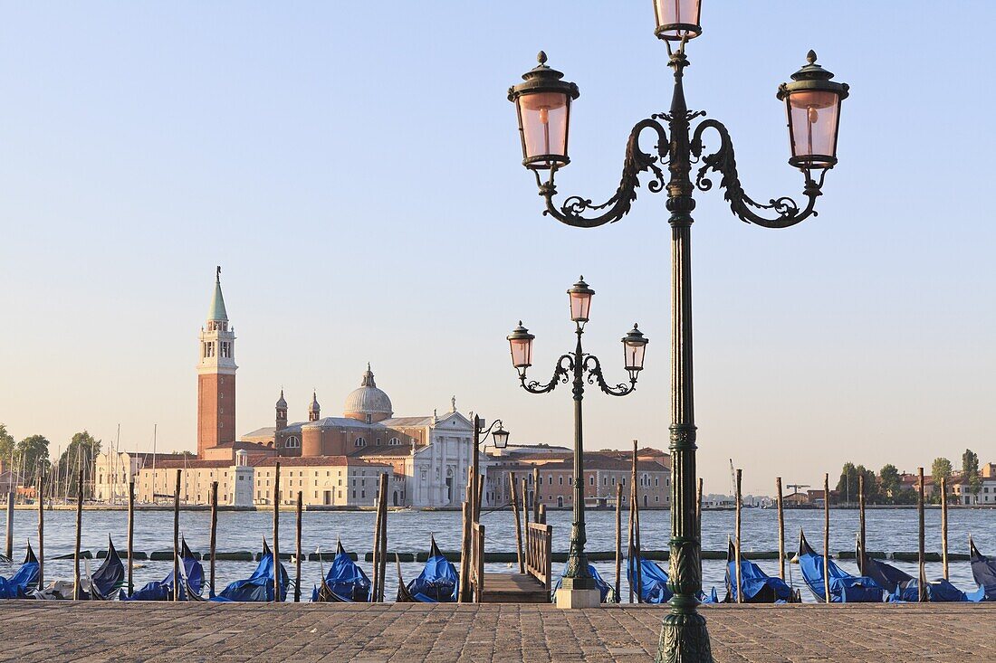 Gondolas moored on the Lagoon, San Giorgio Maggiore beyond, Riva degli Schiavoni, Venice, UNESCO World Heritage Site, Veneto, Italy, Europe