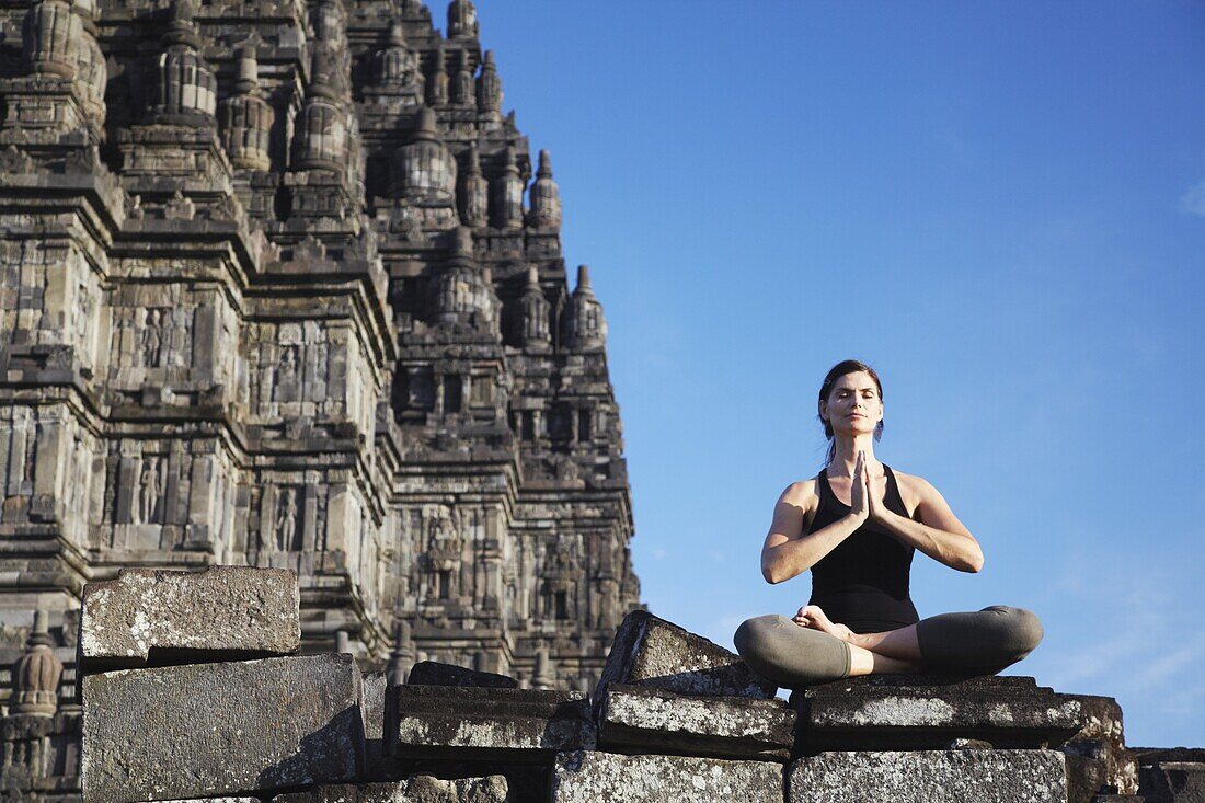 Woman performing yoga, Prambanan complex, UNESCO World Heritage Site, Java, Indonesia, Southeast Asia, Asia