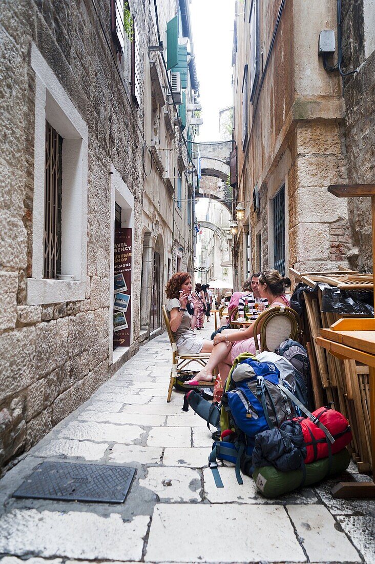 Backpackers outside a bar, Split, region of Dalmatia, Croatia, Europe