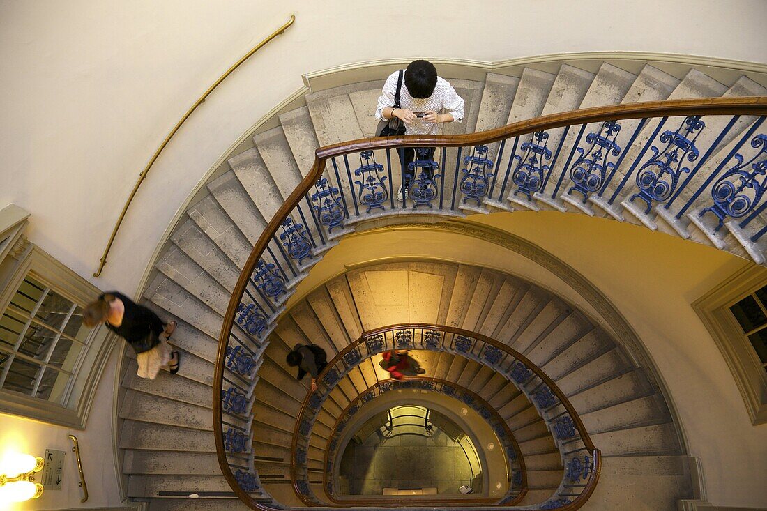 Visitors on  circular stairway, Courtauld Galleries, Somerset House, London, England, United Kingdom, Europe