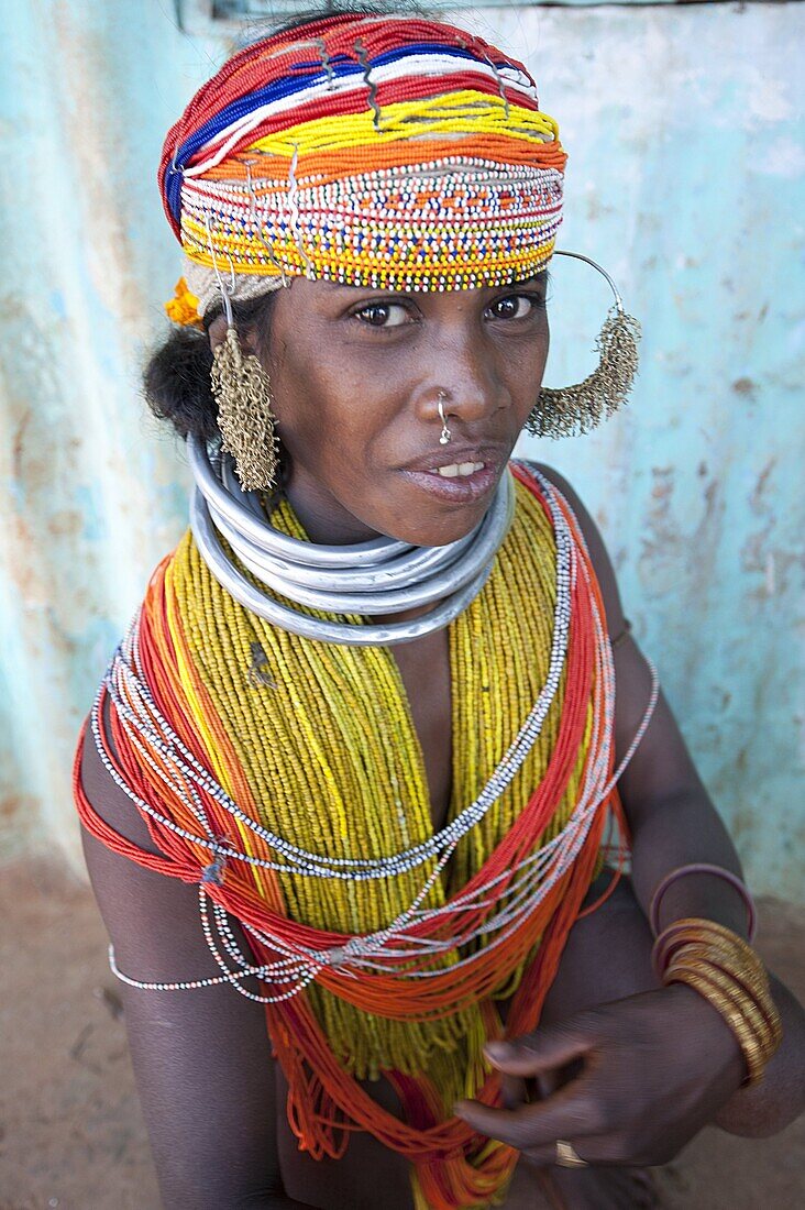 Bonda tribeswoman wearing traditional bead costume with beaded cap, large earrings and metal necklaces at weekly market, Rayagader, Orissa, India, Asia