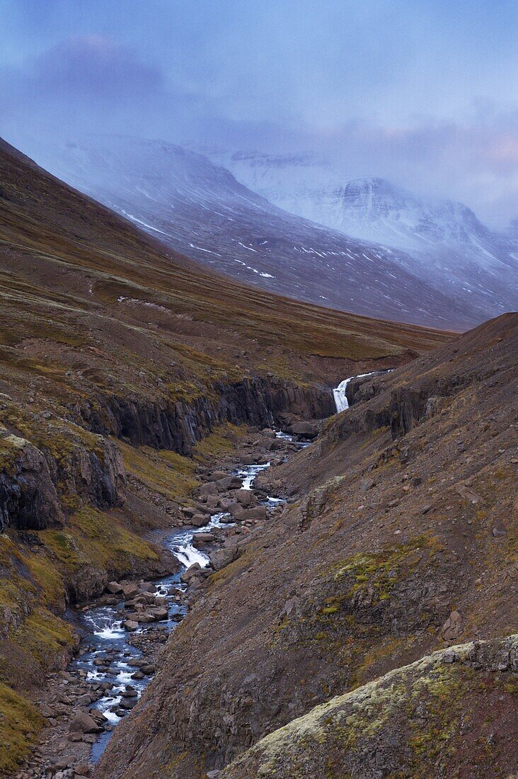 Sunset on snowy mountains in Reydarfjordur fjord, East Fjords, Iceland, Polar Regions