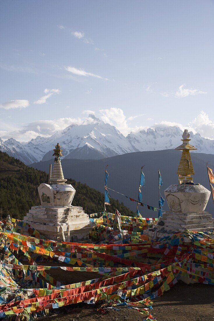 Buddhist stupas on way to Deqin, on the Tibetan Border, with the Meili Snow Mountain peak in the background, Dequin, Shangri-La region, Yunnan Province, China, Asia