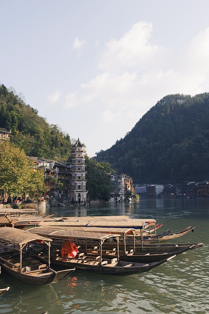 Boats tied up on a river in the old town of Fenghuang, Hunan Province, China, Asia