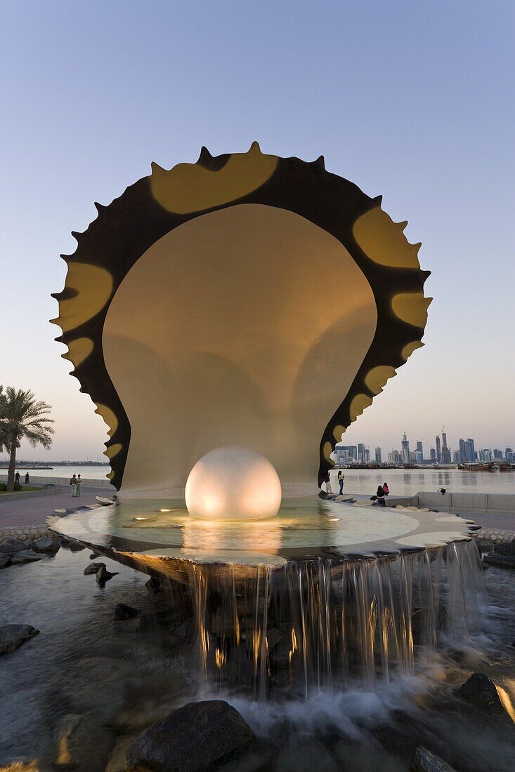 Pearl Monument on the Corniche of Doha Bay with the central business district of the West Bay on the horizon, Doha, Qatar, Middle East