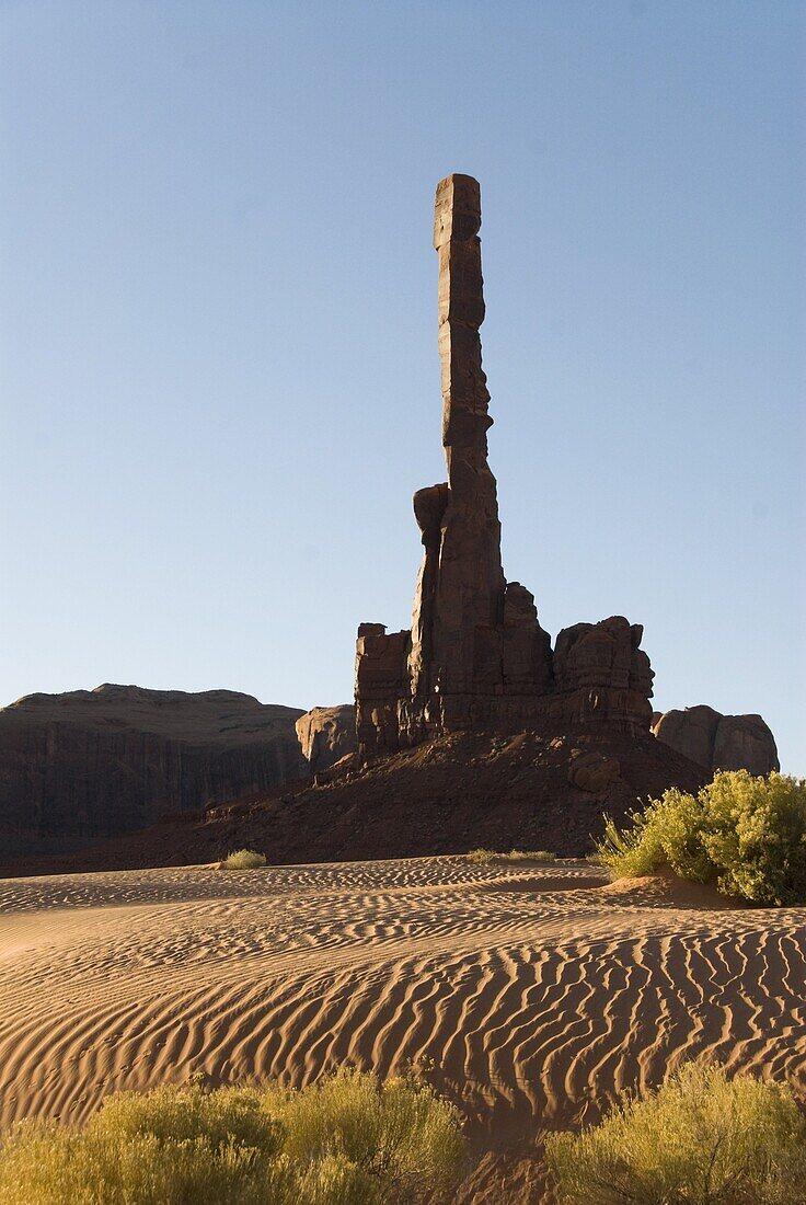 Early morning view of the Totem Pole with sand dunes in the foreground, Monument Valley, Arizona, United States of America, North America