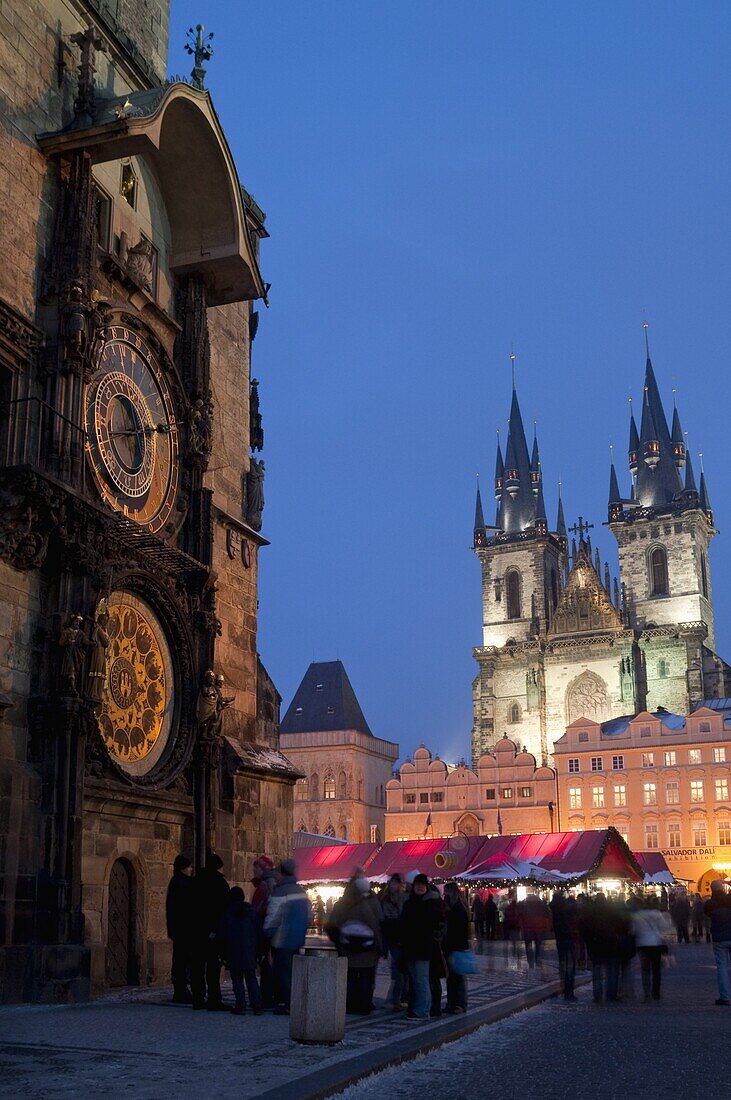 Astronomical Clock of Gothic Old Town Hall, stalls of Christmas Market, and Gothic Tyn Church, at twilight, Old Town Square, Stare Mesto, Prague, Czech Republic, Europe