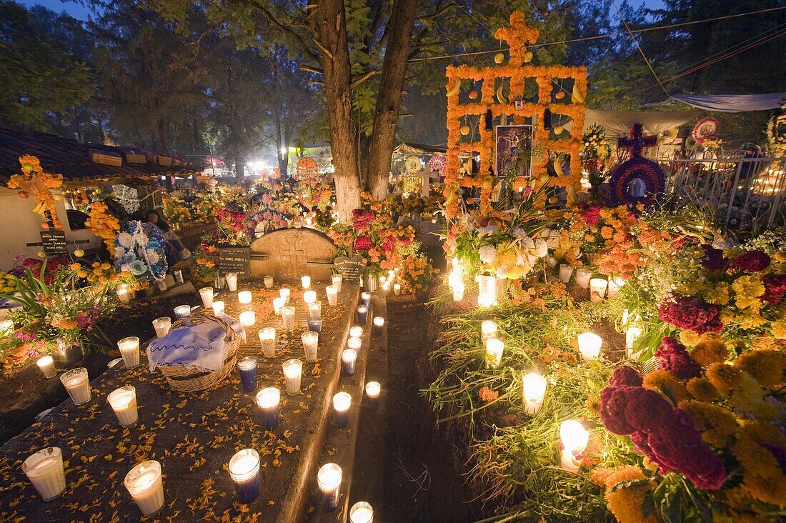 A candle lit grave, Dia de Muertos (Day of the Dead) celebrations in a cemetery in Tzintzuntzan, Lago de Patzcuaro, Michoacan state, Mexico, North America