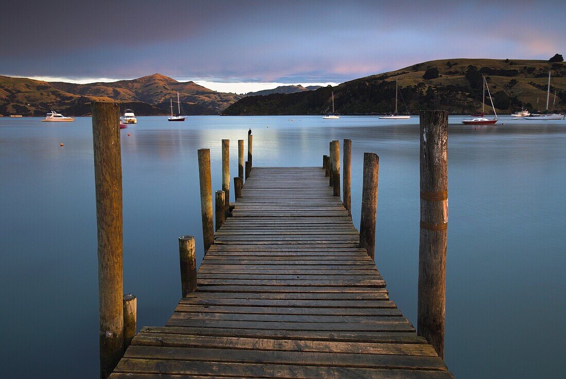 Early morning beside a jetty overlooking Akaroa harbour, Banks Peninsula, South Island, New Zealand, Pacific