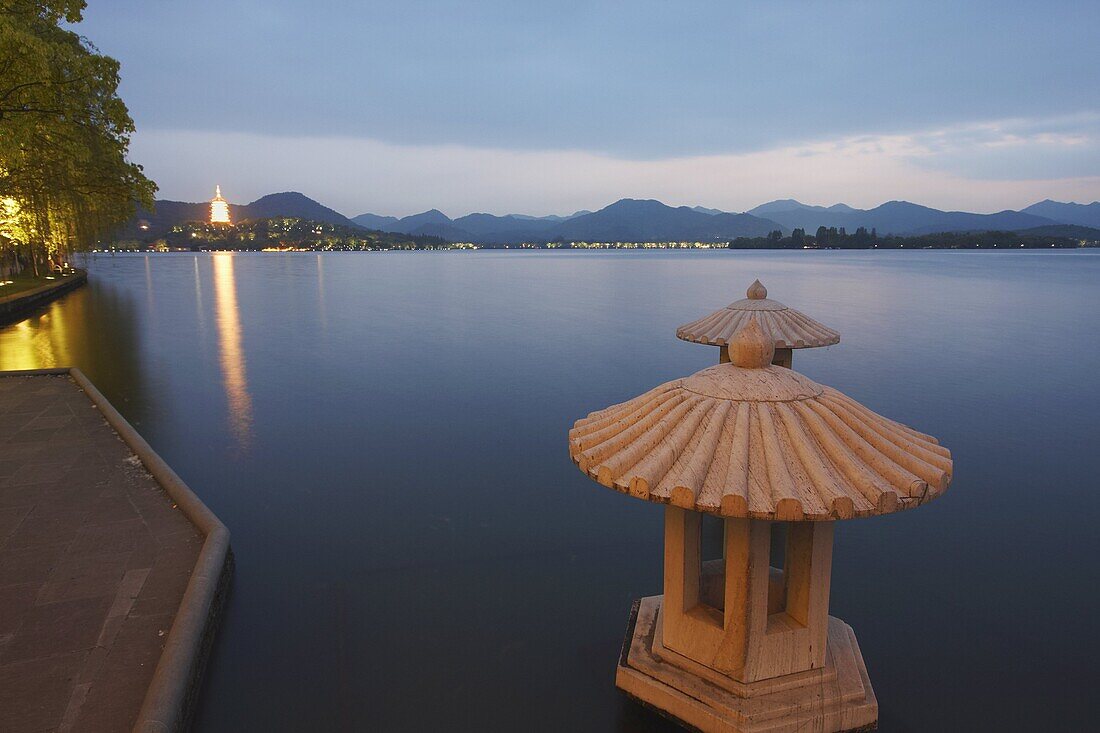 Xi Hu (West Lake) at dusk with Jinci Si Pagoda in background, Hangzhou, Zhejiang, China, Asia