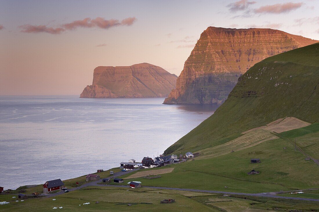 Village of Trollanes on Kalsoy, with view of Kunoy and Vidoy high cliffs of Kunoyarnakkur and Villingadalsfjall, across Kalsoyarfjordur, Kalsoy Island, Nordoyar, Faroe Islands (Faroes), Denmark, Europe
