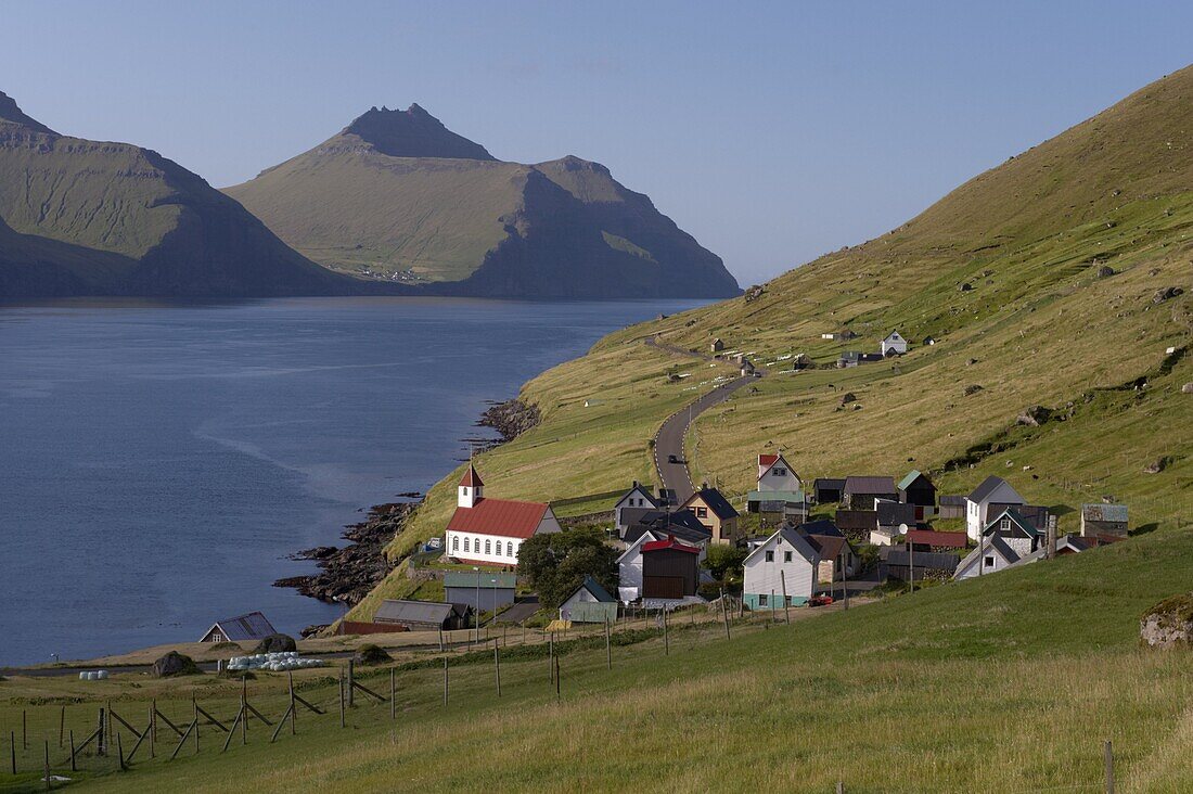 Village of Kunoy, located on the west coast of the island Kunoy, impressively surrounded by high mountains, Kunoy Island, Nordoyar, Faroe Islands (Faroes), Denmark, Europe