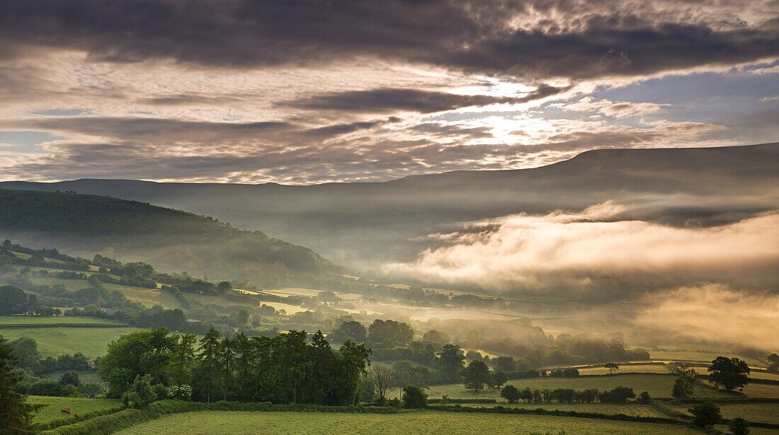 Mist hanging over countryside near Bwlch,  Brecon Beacons National Park,  Powys,  Wales,  United Kingdom,  Europe