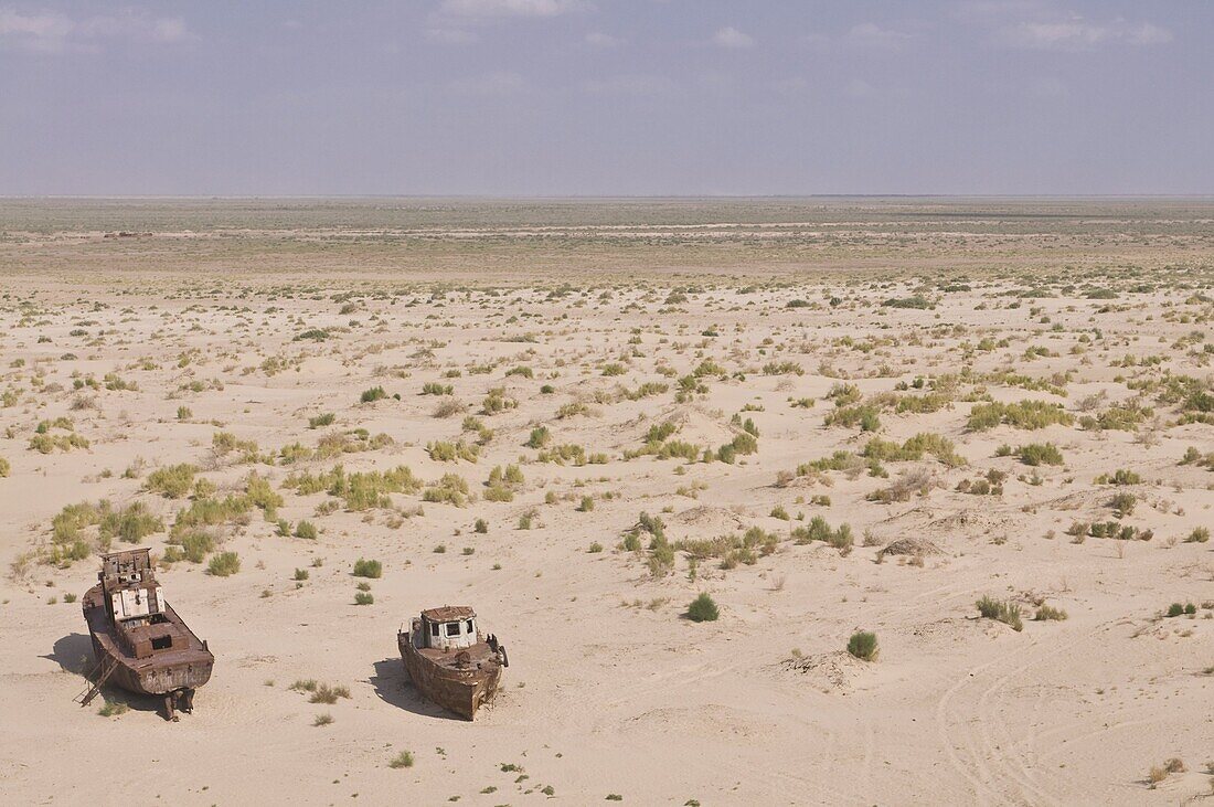 Rusting boats lying in the desert which used to be the Aral Sea,  Moynaq,  Uzbekistan,  Central Asia