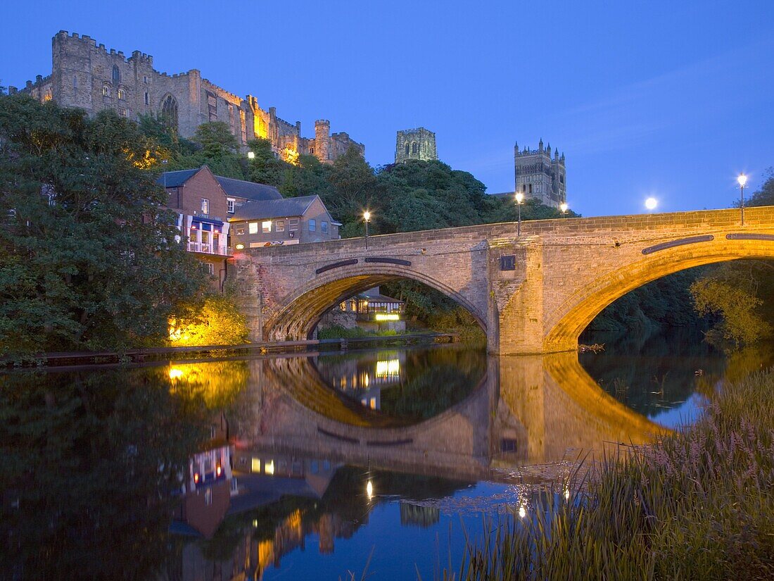 View to the illuminated castle and cathedral across the River Wear below Framwellgate Bridge, Durham, County Durham, England, United Kingdom, Europe