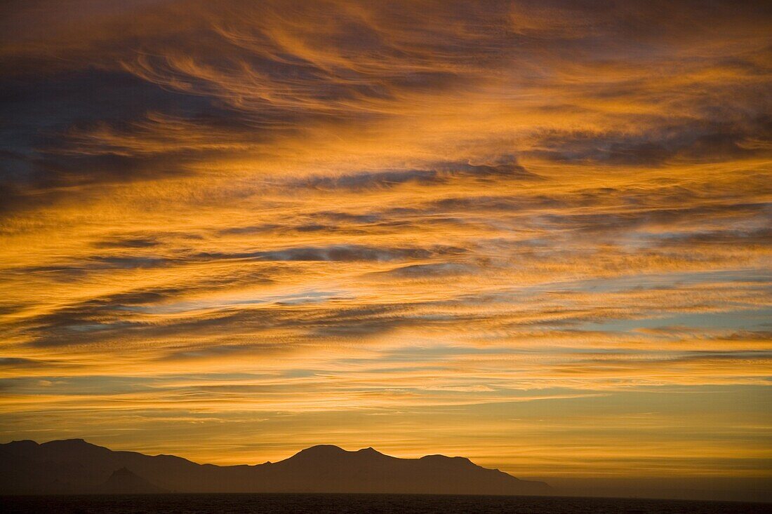 Sunset with deep orange clouds, Bransfield Strait, view from South Shetland Islands to Antarctic Peninsula, Antarctica, Polar Regions