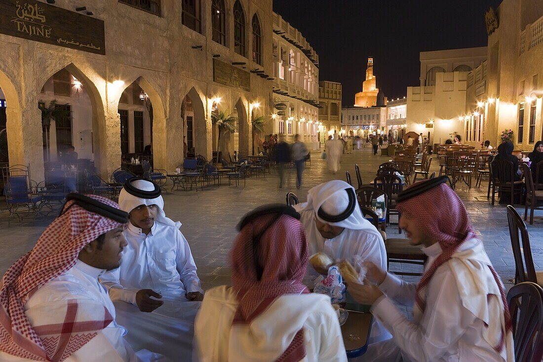 A group of men in Arabian dress in the restored Souq Waqif, Doha, Qatar, Middle East