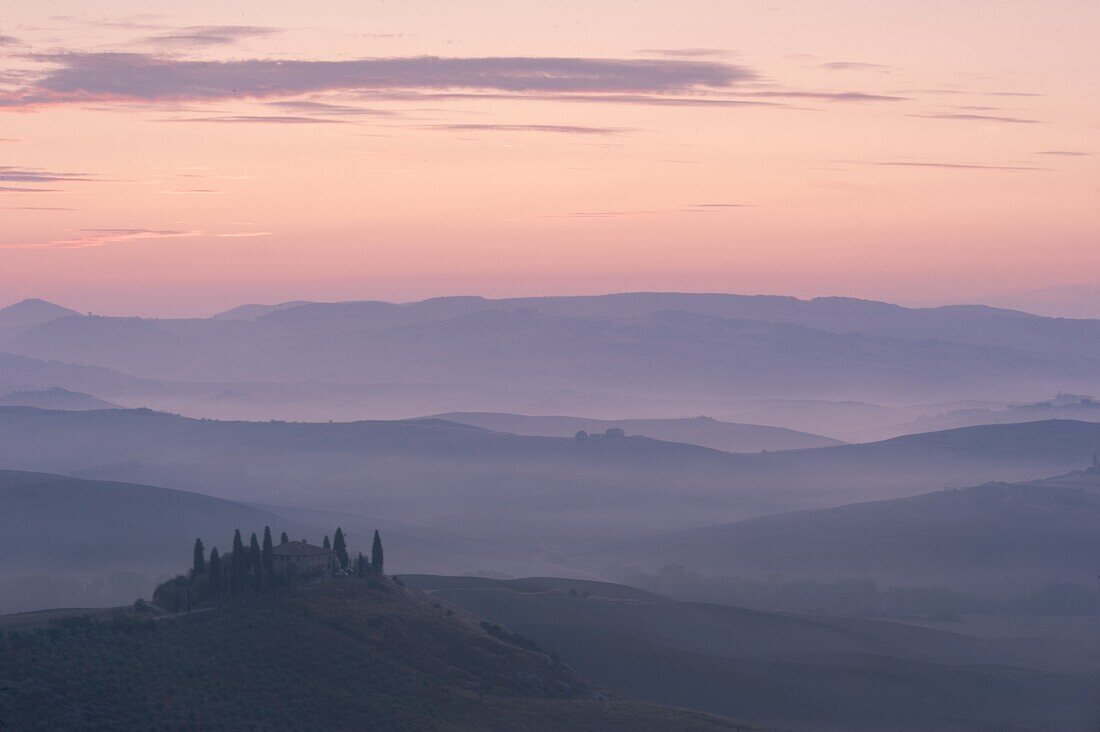 A dawn view over the misty hills of Val d'Orcia and the Belvedere, San Quirico d'Orcia, UNESCO World Heritage Site, Tuscany, Italy, Europe