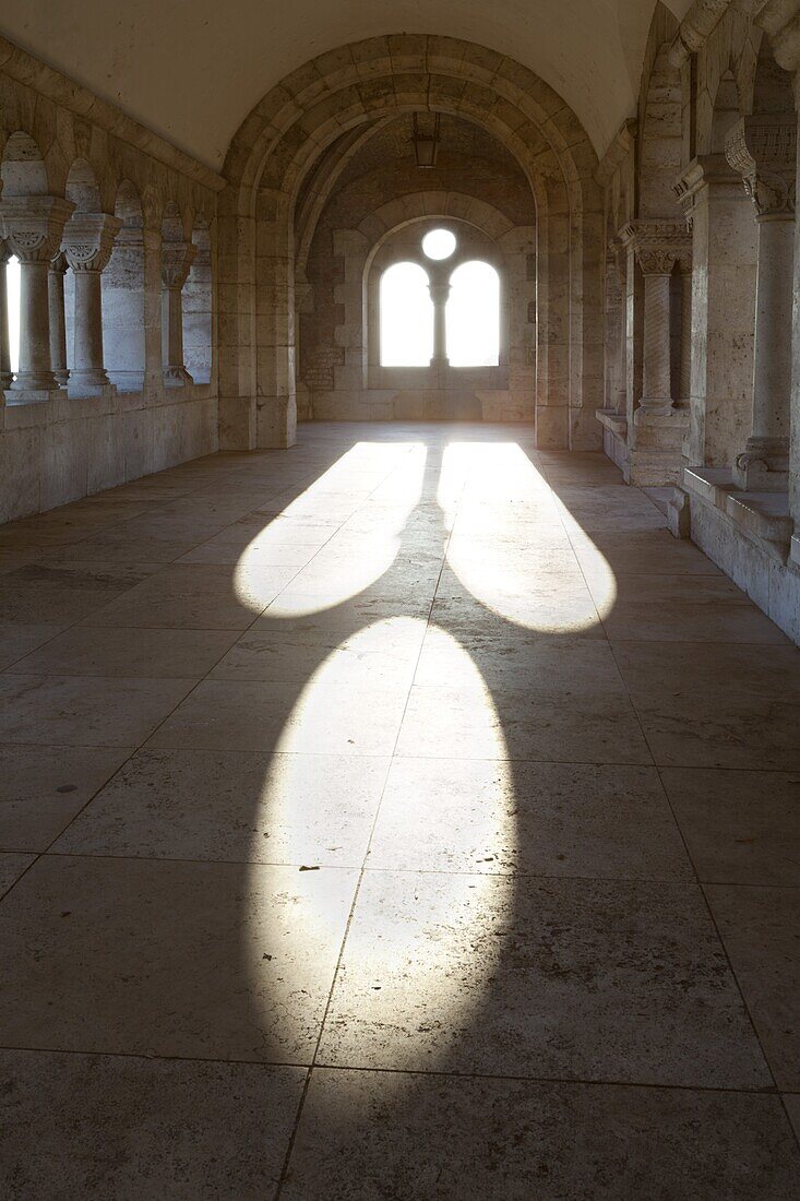 Sunlight pouring through arched windows, Fishermen's Bastion (Halaszbastya), Buda, Budapest, Hungary, Europe