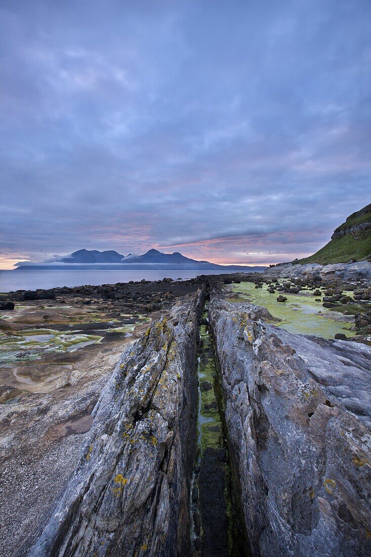 Dusk on the Isle of Eigg with Rum in the distance, Inner Hebrides, Scotland, United Kingdom, Europe