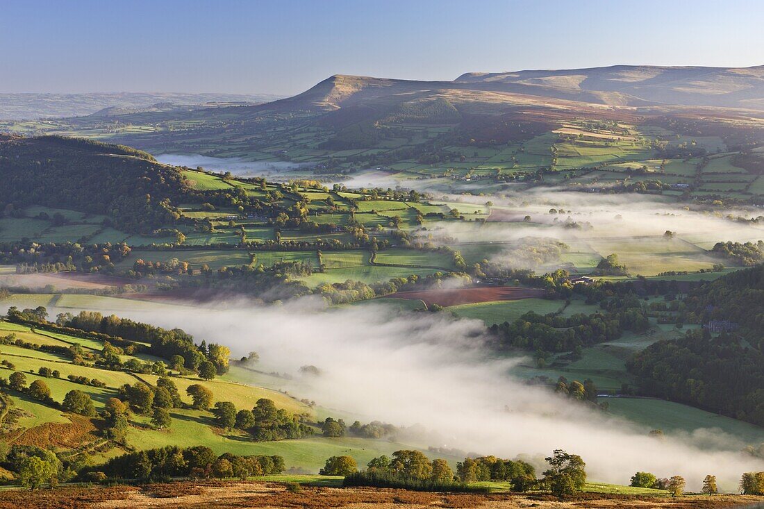 Mist covered rolling countryside backed by the Black Mountains, Brecon Beacons National Park, Powys, Wales, United Kingdom, Europe