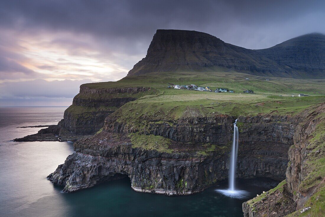 Dramatic coastal scenery at Gasadalur on the island of Vagar, Faroe Islands, Denmark, Europe
