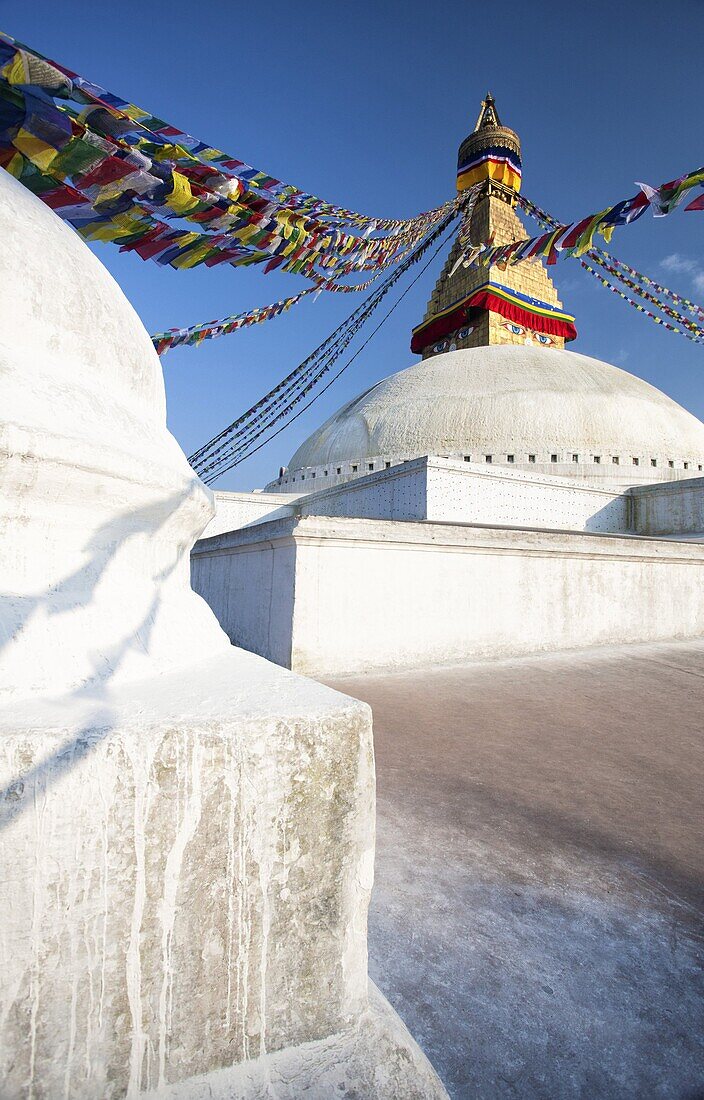 Bodhnath Stupa (Boudhanth) (Boudha), one of the holiest Buddhist sites in Kathmandu, UNESCO World Heritage Site, with colourful prayer flags against clear blue sky, Kathmandu, Nepal, Asia